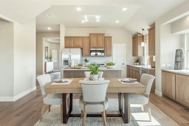 a dining room with furniture a window and kitchen view