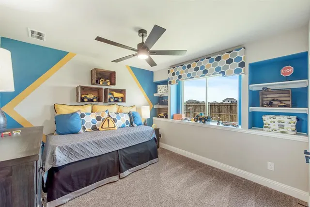 a bedroom with furniture and a large window