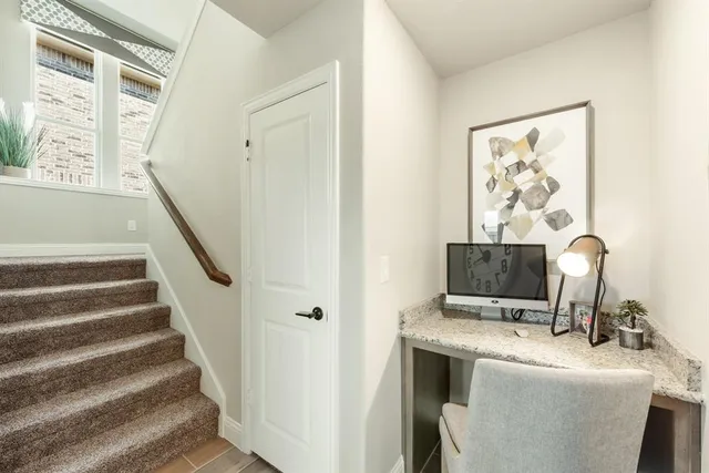 a view of a hallway with workspace and stairs