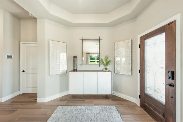 a view of a kitchen with wooden floor and a refrigerator
