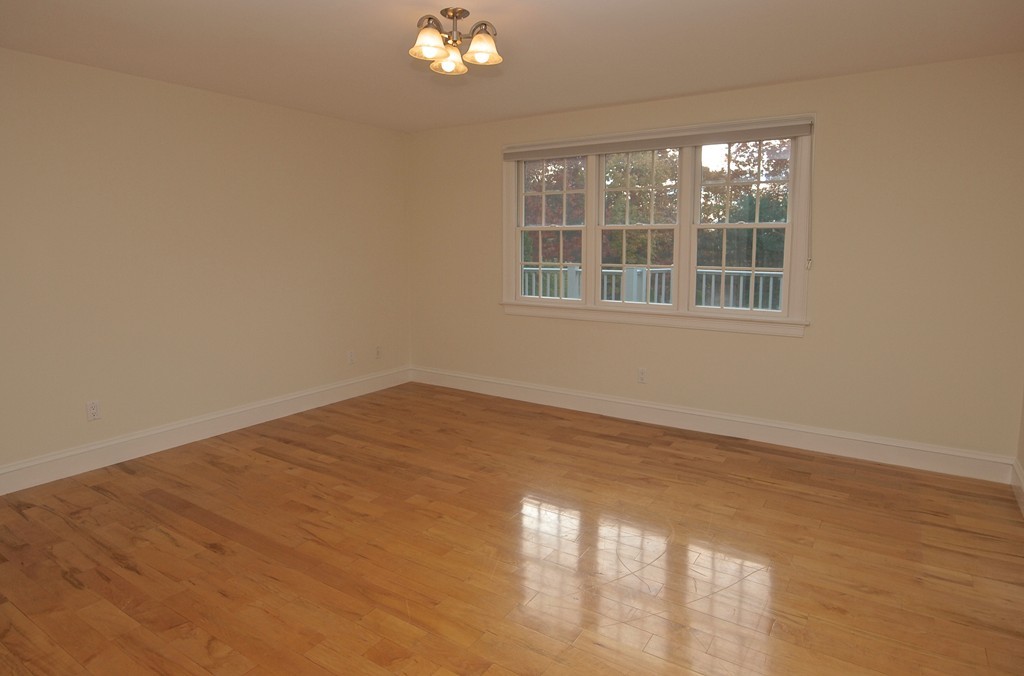 218 Bridle Trail Road Needham, MA 02492 - Photo 18 of 30 a view of empty room with wooden floor and fan
