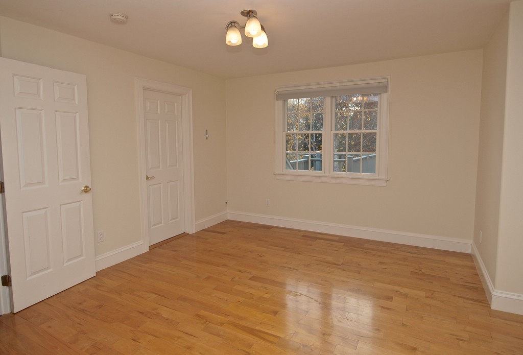 218 Bridle Trail Road Needham, MA 02492 - Photo 19 of 30 an empty room with wooden floor and windows