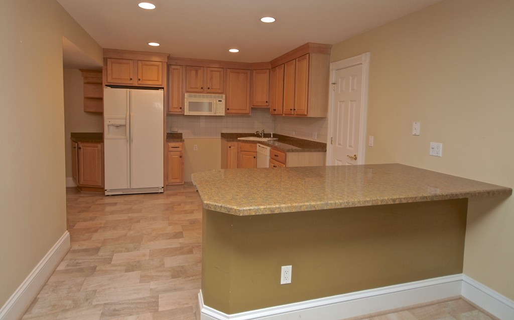 218 Bridle Trail Road Needham, MA 02492 - Photo 25 of 30 a view of a refrigerator in kitchen and wooden floor