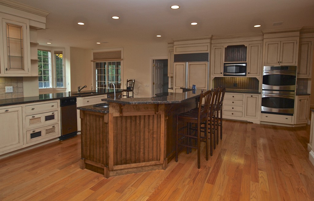 218 Bridle Trail Road Needham, MA 02492 - Photo 9 of 30 a kitchen with stainless steel appliances granite countertop a stove a sink dishwasher and a microwave oven with wooden floor