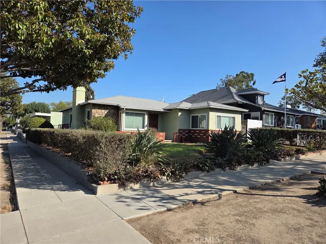 a front view of house with yard and trees around
