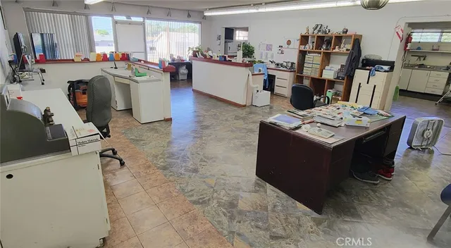 a living room with lots of furniture and clutter
