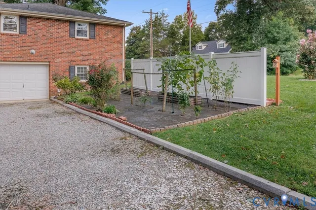 a backyard of a house with chairs and table