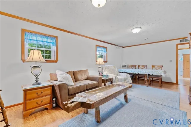 a room with wooden floor and furniture