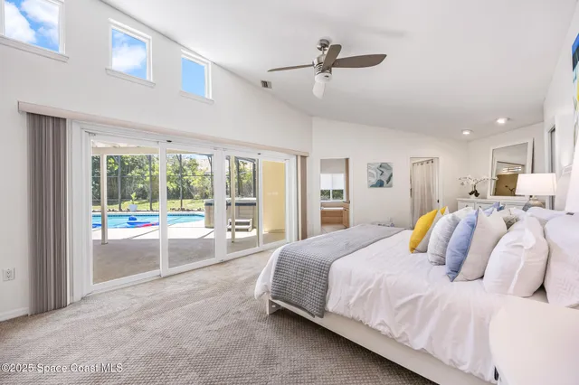 a bedroom with a large bed and a large window