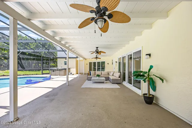 a view of a livingroom with furniture and a ceiling fan