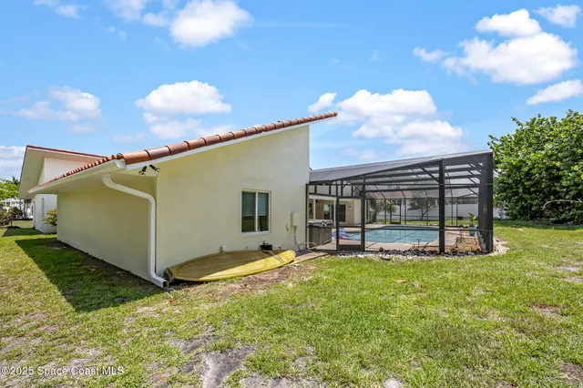 a view of a house with backyard and sitting area