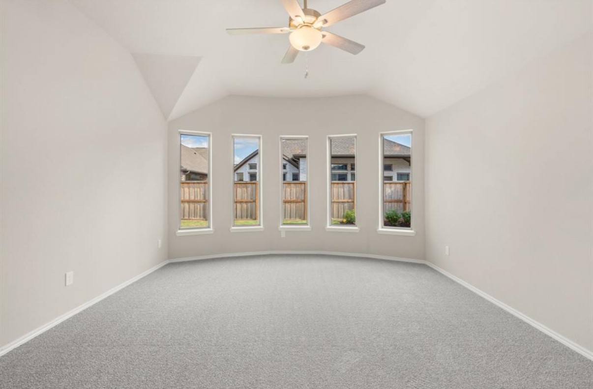 13814 San Pasqual Pointe Drive Cypress, TX 77433 - Photo 11 of 24 an empty room with windows and chandelier fan
