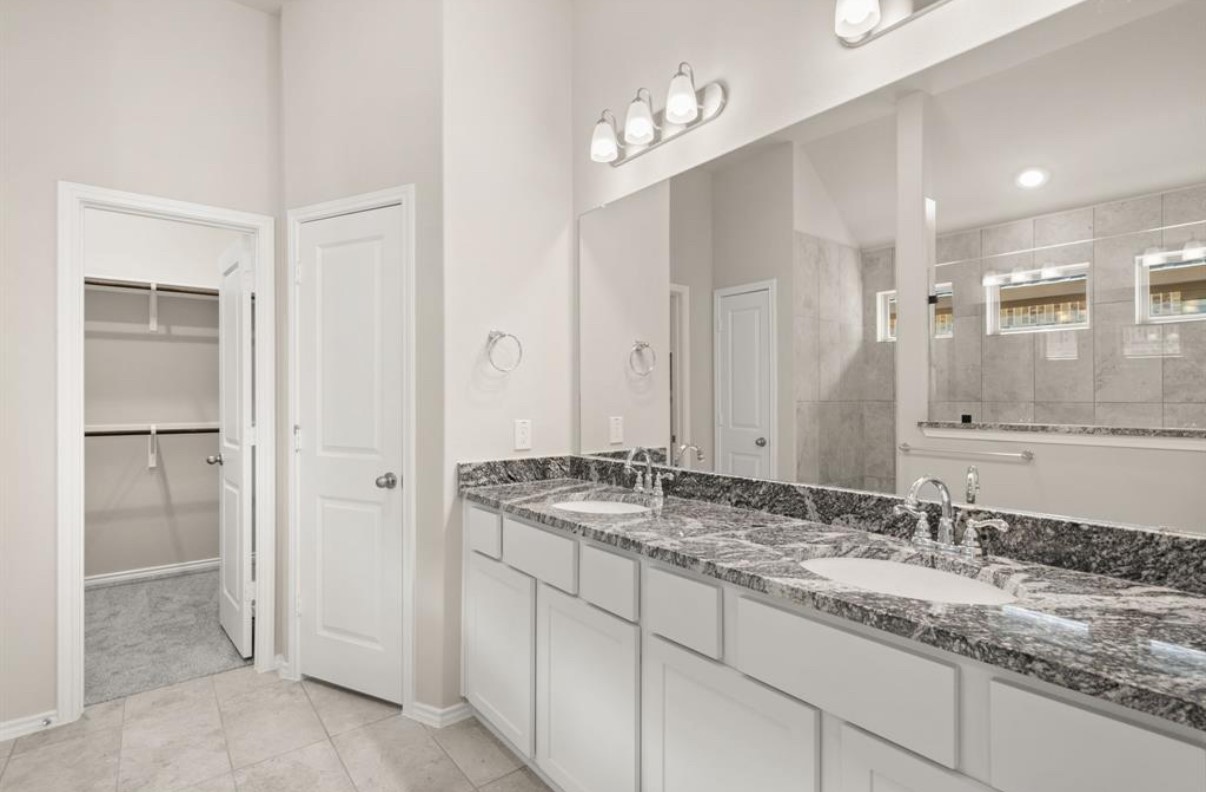 13814 San Pasqual Pointe Drive Cypress, TX 77433 - Photo 13 of 24 a bathroom with a granite countertop sink and a mirror