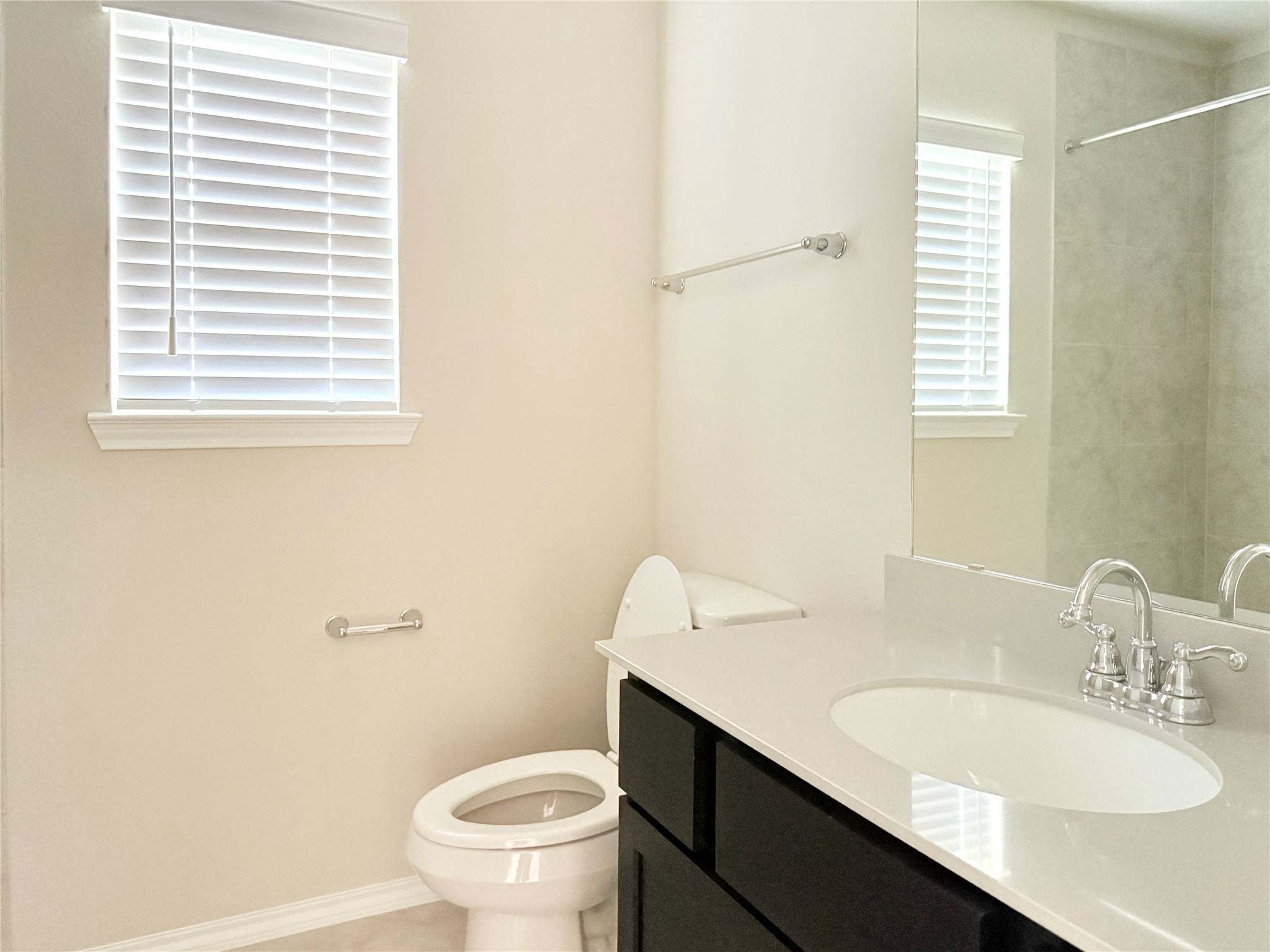 13814 San Pasqual Pointe Drive Cypress, TX 77433 - Photo 17 of 24 a bathroom with a granite countertop sink toilet and a mirror