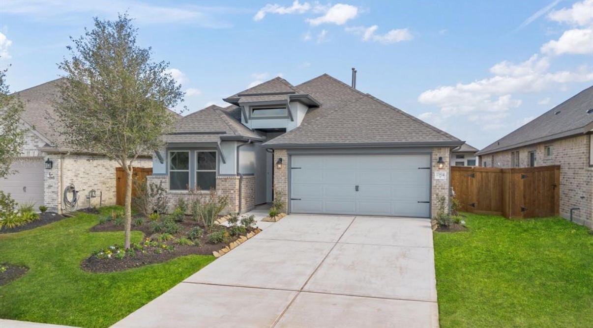 13814 San Pasqual Pointe Drive Cypress, TX 77433 - Photo 2 of 24 a front view of a house with garden
