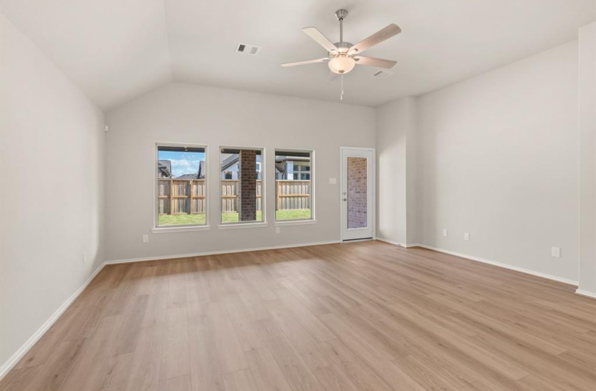 13814 San Pasqual Pointe Drive Cypress, TX 77433 - Photo 6 of 24 an empty room with wooden floor ceiling fan and windows