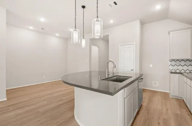 a kitchen with sink and refrigerator