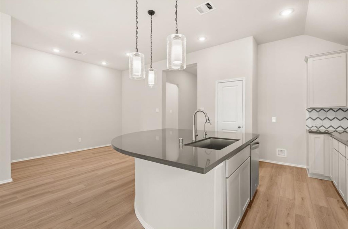 13814 San Pasqual Pointe Drive Cypress, TX 77433 - Photo 9 of 24 a kitchen with sink and refrigerator