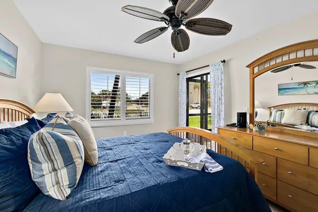 a view of two chairs in a room next to a yard