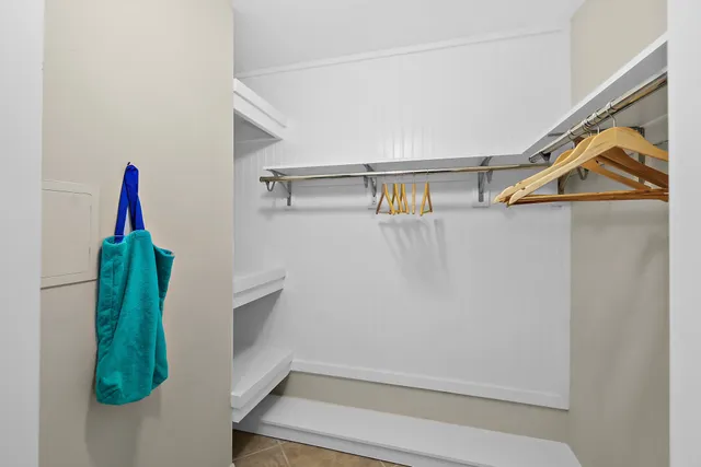 a view of a house with a yard and potted plants