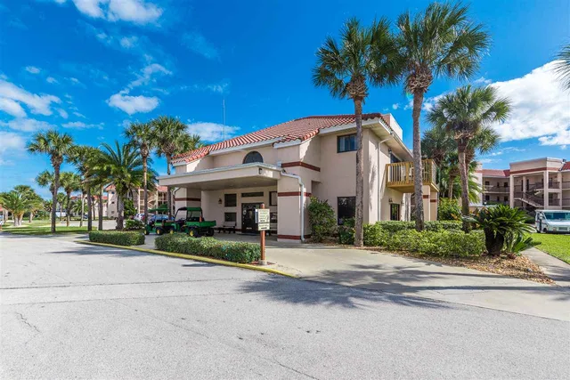 a view of a street with potted plants