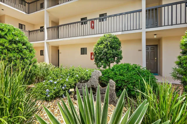 a kitchen with a refrigerator and a stove top oven