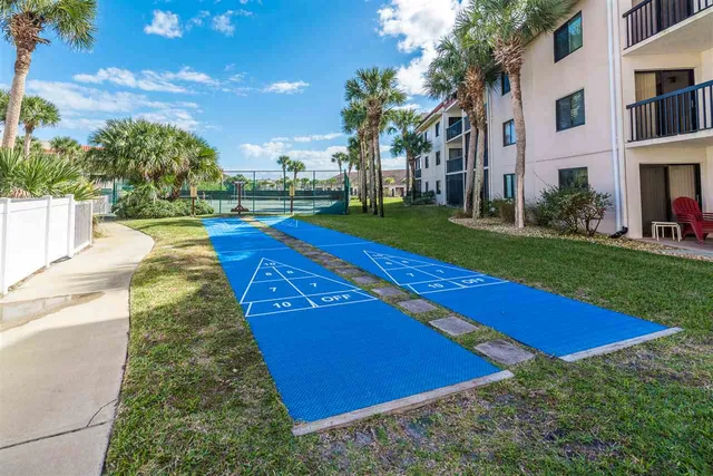a front view of a house with a yard table and chairs