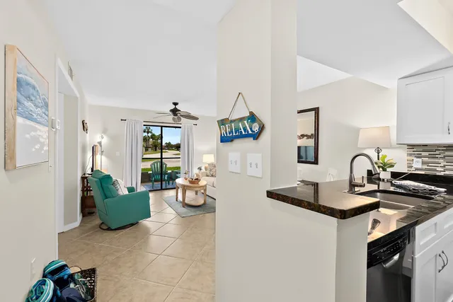 a kitchen with granite countertop a sink stainless steel appliances and cabinets