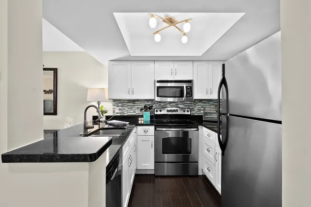 a kitchen with stainless steel appliances a stove and a microwave
