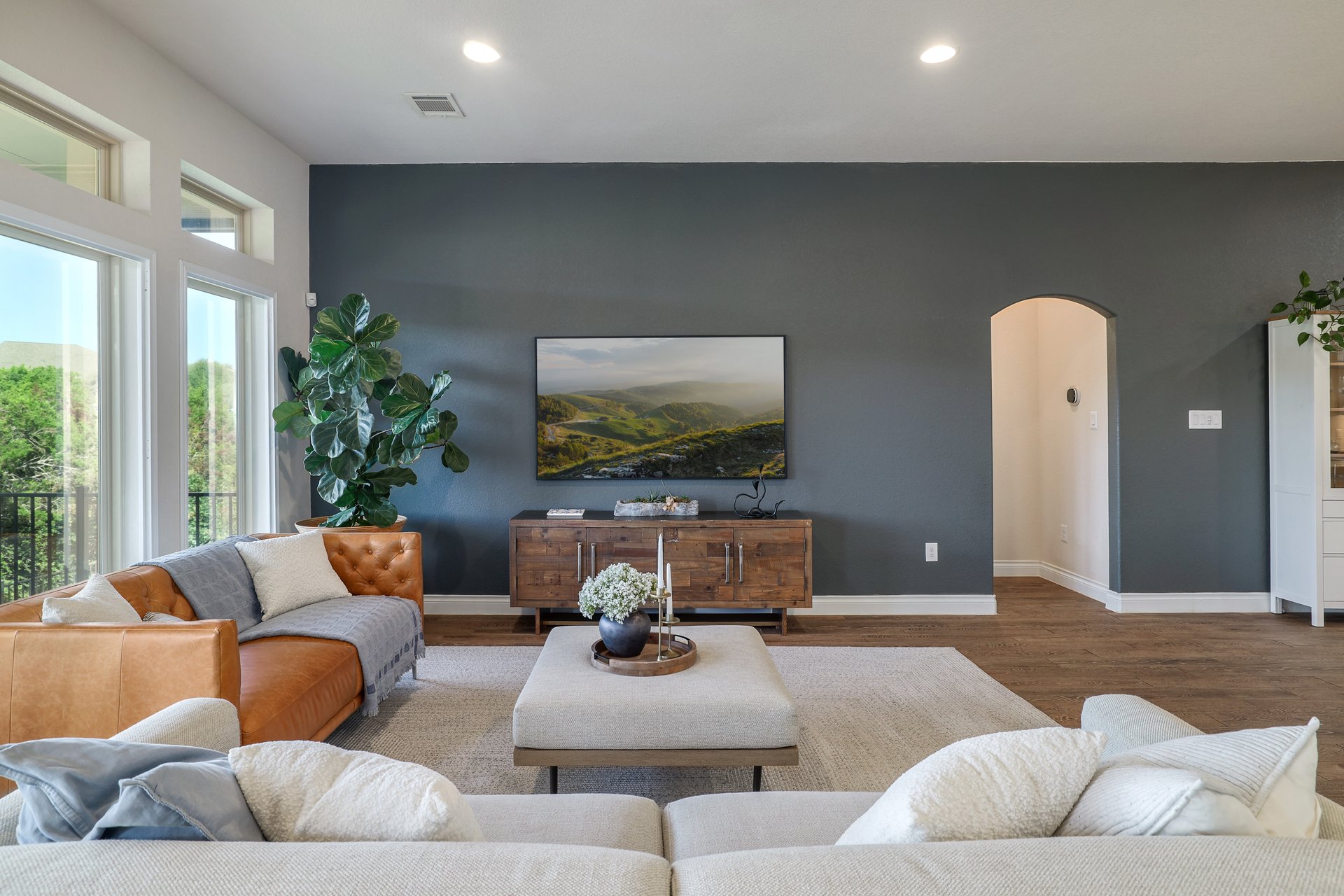 173 Santa Maria Street Georgetown, TX 78628 - Photo 13 of 39 Spacious living area featuring wood-finish flooring, a contemporary dark accent wall, recessed lighting, and large windows