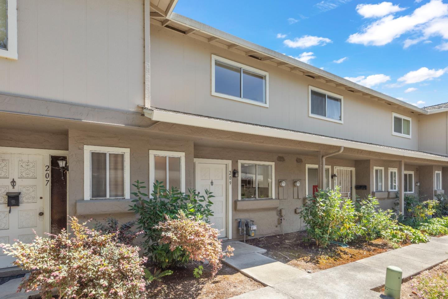 a front view of a house with garden