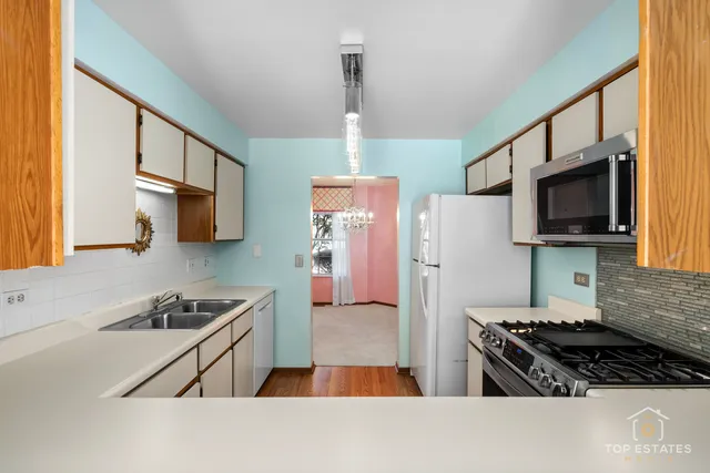 a kitchen with stainless steel appliances granite countertop a stove and a refrigerator