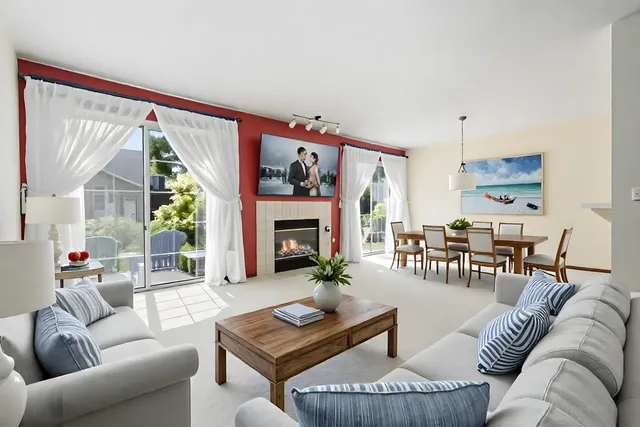 a living room with furniture fireplace and a large window