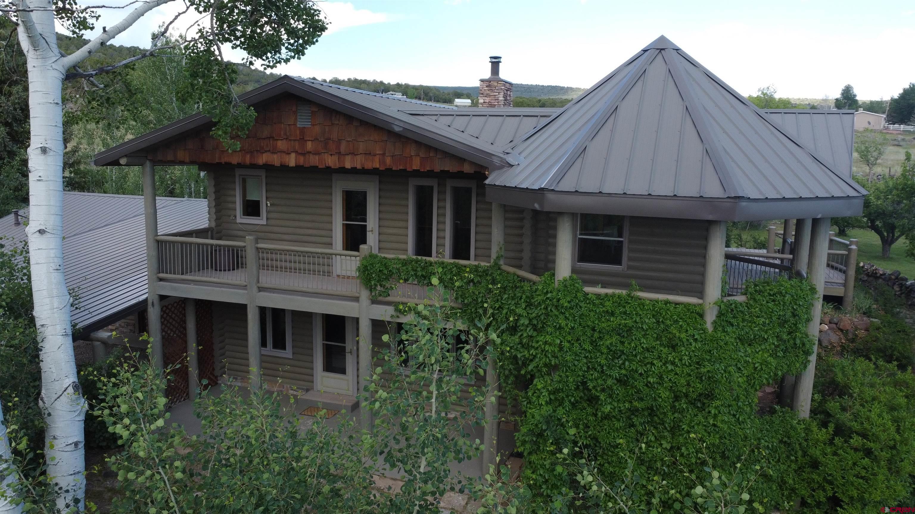 24119 Ute Trail Road Cedaredge, CO 81413 - Photo 21 of 26 a front view of a house with a garden