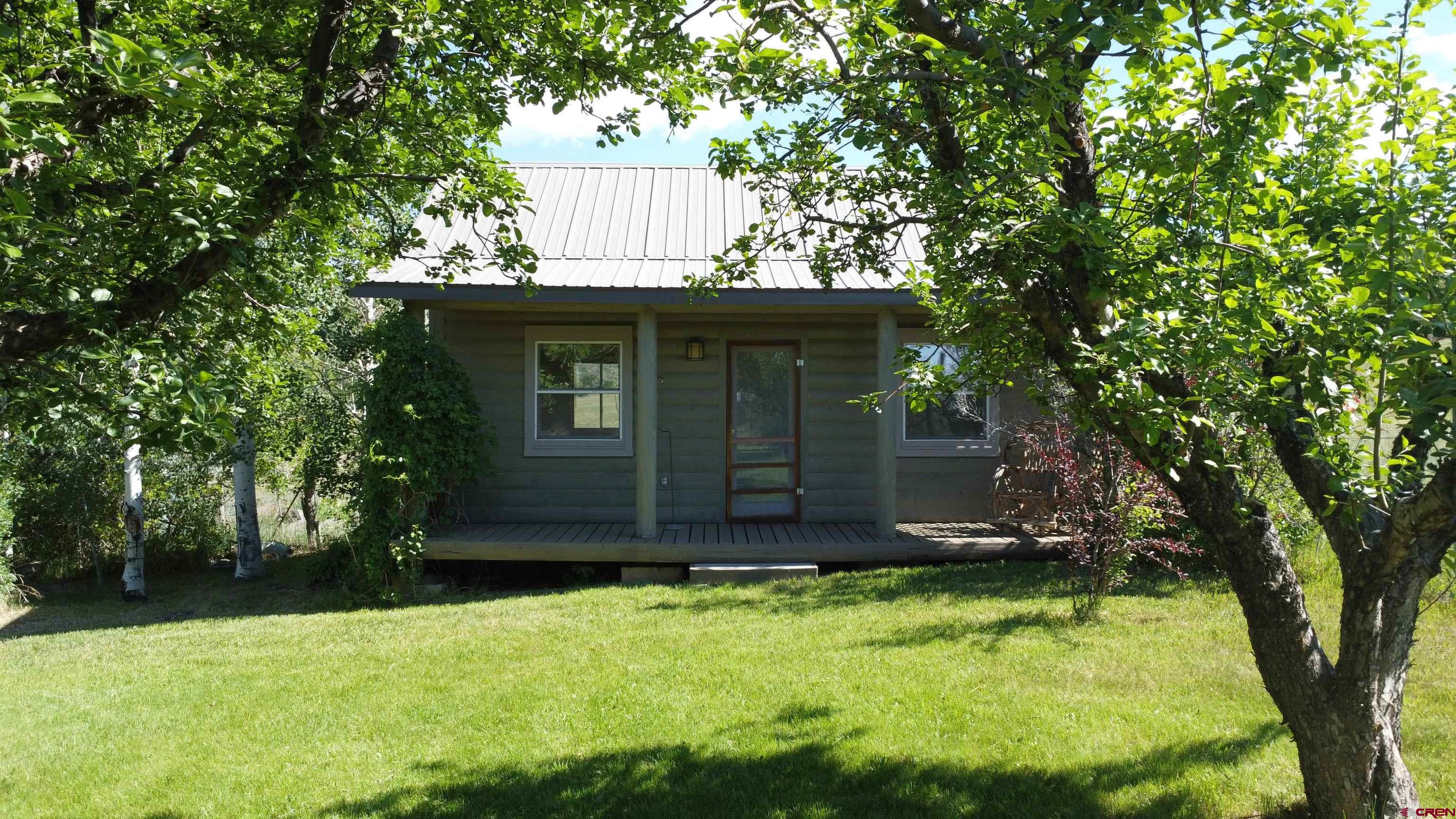 24119 Ute Trail Road Cedaredge, CO 81413 - Photo 5 of 26 a view of a backyard with a tree