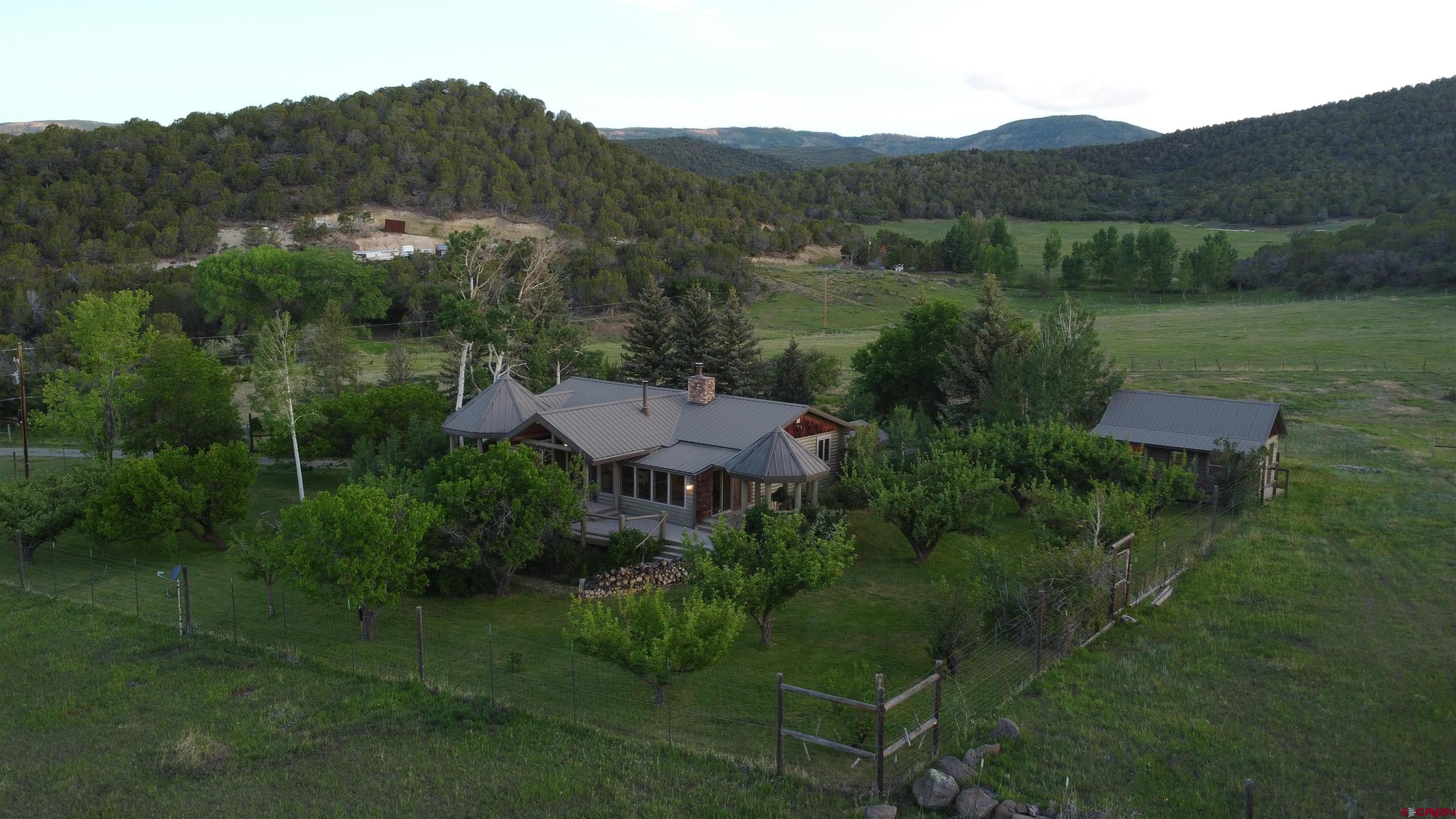 24119 Ute Trail Road Cedaredge, CO 81413 - Photo 6 of 26 a view of a lush green field with a sink in the background