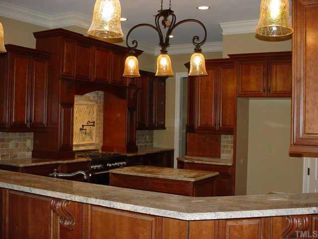 3208 Cotten Road, Unit LOT89 Raleigh, NC 27603 - Photo 3 of 12 The kitchen is awesome! Granite counters, island, tons of cabinets, 6-burner range, double ovens, microwave, pantry, tile backsplash -- wow! Other