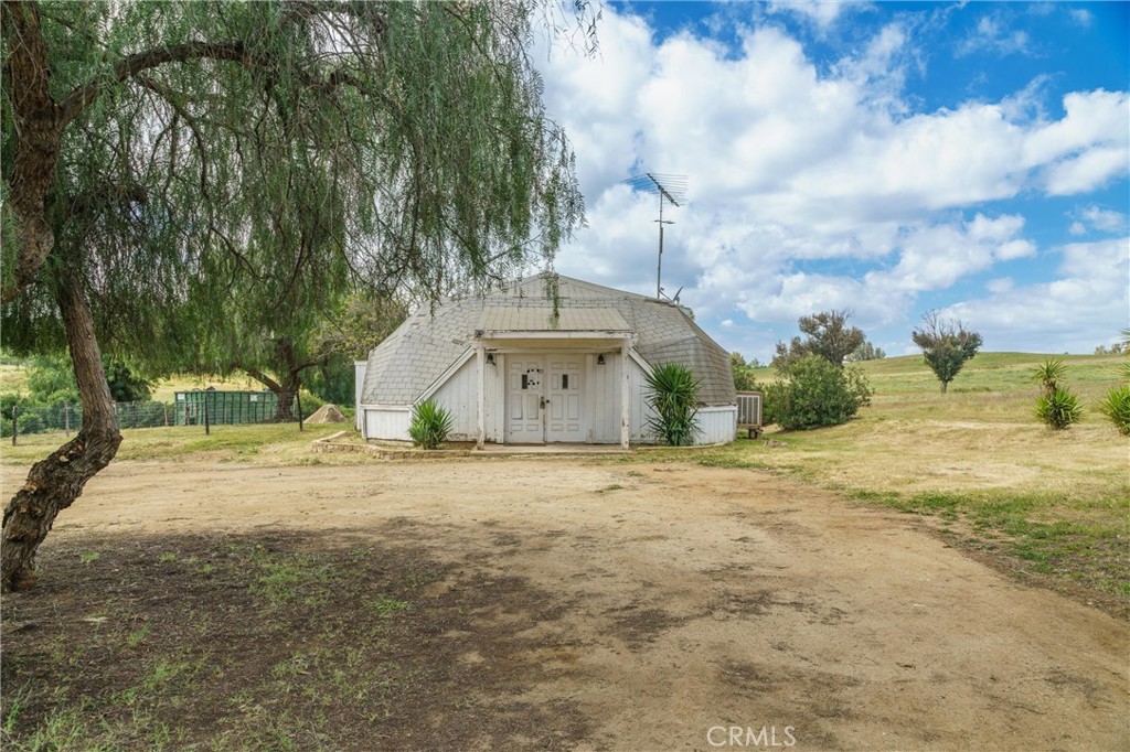 33041 Briggs Road Menifee, CA 92584 - Photo 13 of 60 a front view of a house with a yard and garage