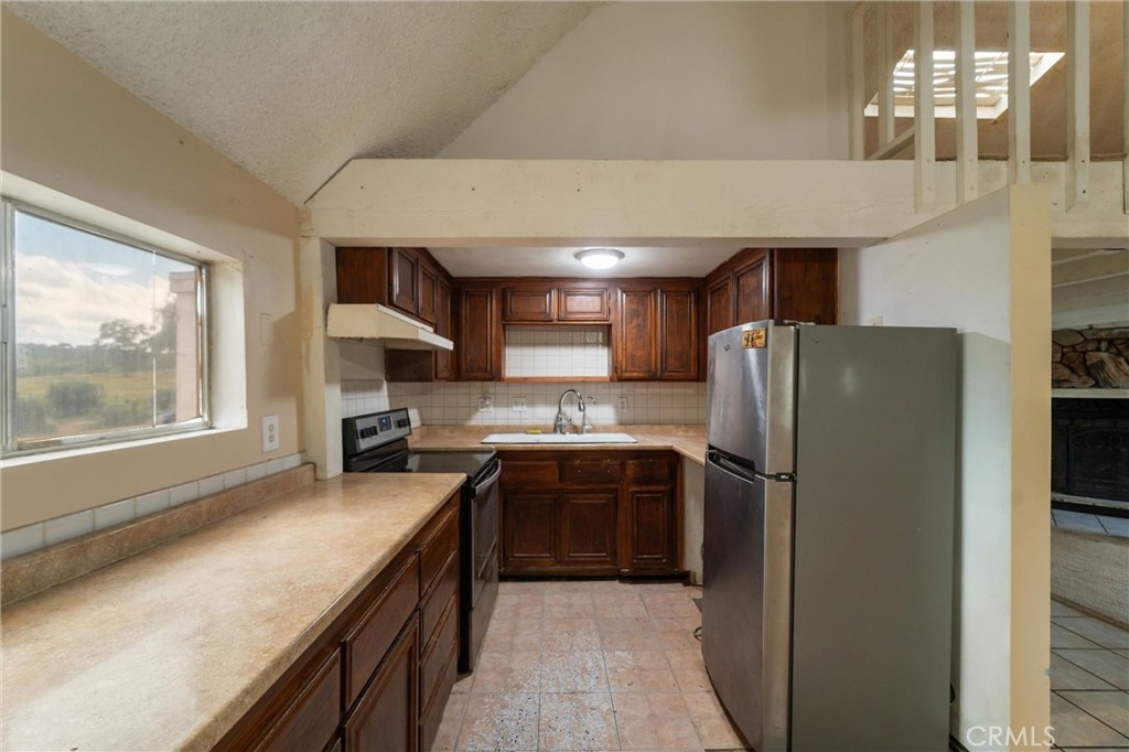 33041 Briggs Road Menifee, CA 92584 - Photo 16 of 60 a kitchen with stainless steel appliances granite countertop a refrigerator a sink a stove and a refrigerator