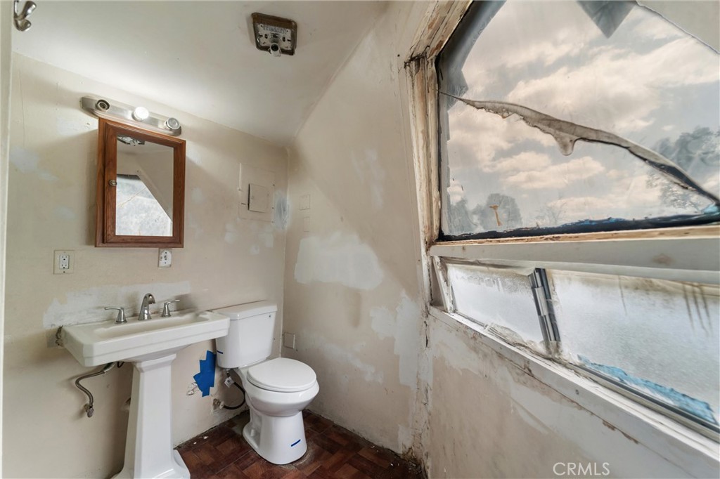 33041 Briggs Road Menifee, CA 92584 - Photo 18 of 60 a bathroom with a toilet sink and mirror