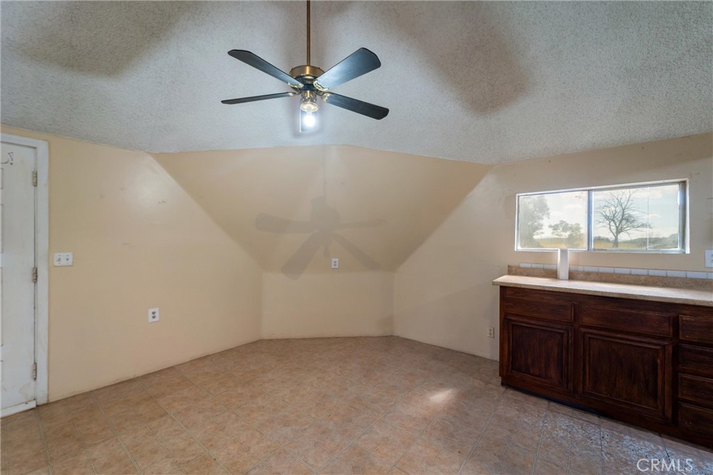 33041 Briggs Road Menifee, CA 92584 - Photo 22 of 60 a view of an empty room with a window and a chandelier fan