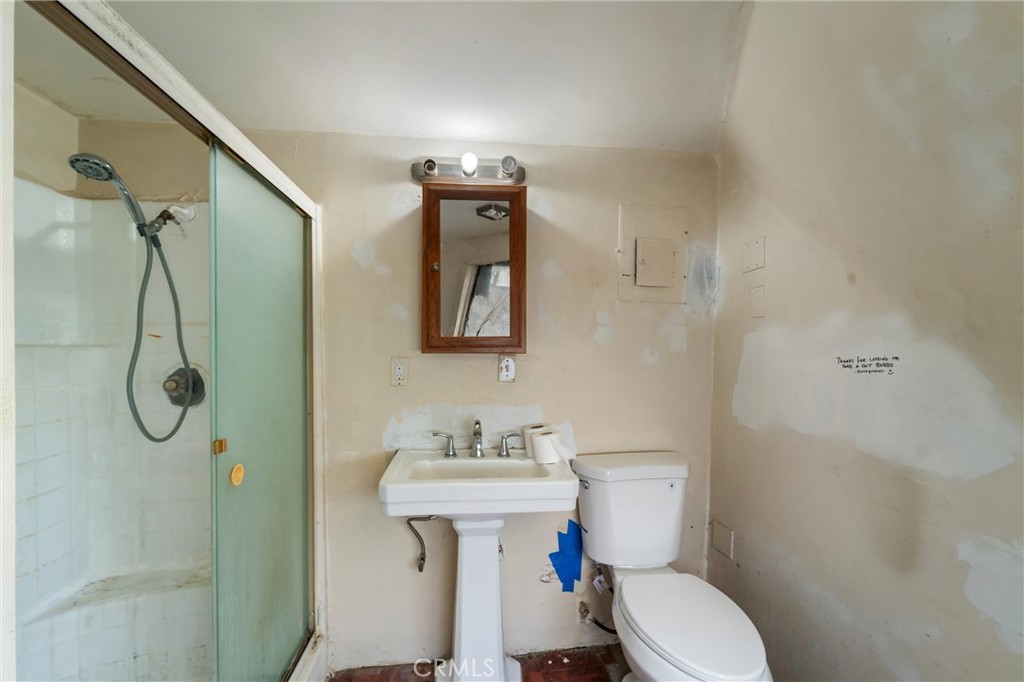 33041 Briggs Road Menifee, CA 92584 - Photo 24 of 60 a bathroom with a toilet sink shower and mirror