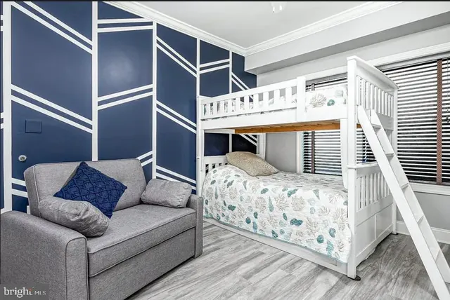 a bed sitting in a bedroom next to a window with a bedroom