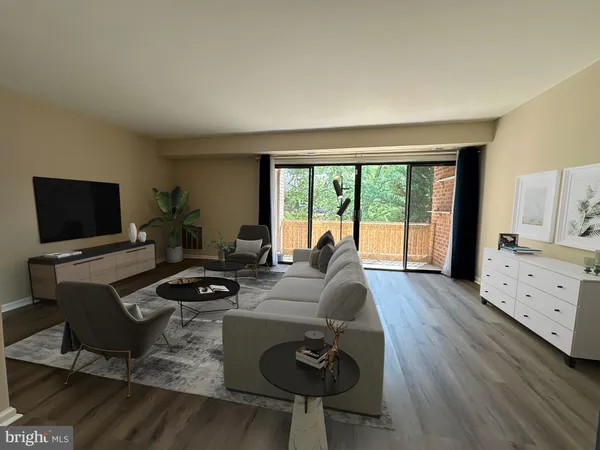a living room with furniture a flat screen tv and a floor to ceiling window
