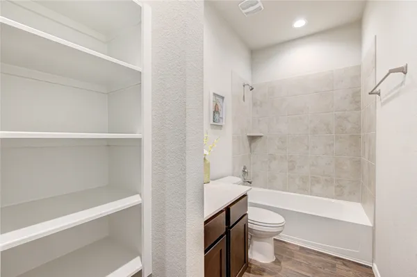 a bathroom with a toilet a sink and bathtub