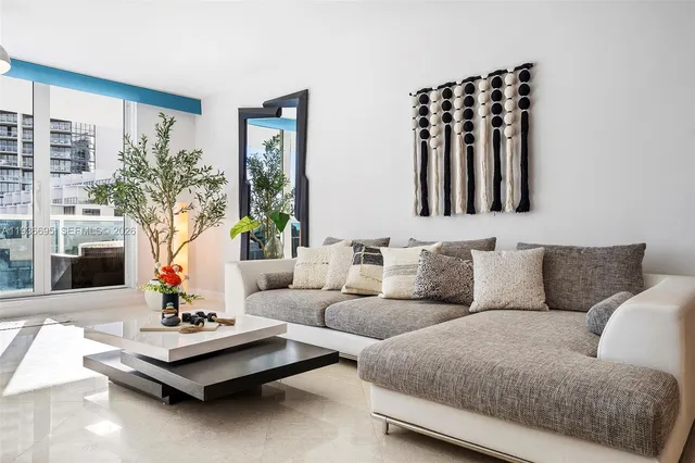 a living room with furniture and a potted plant