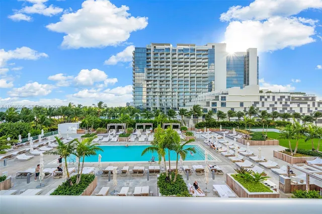 a bedroom with bed and a large window