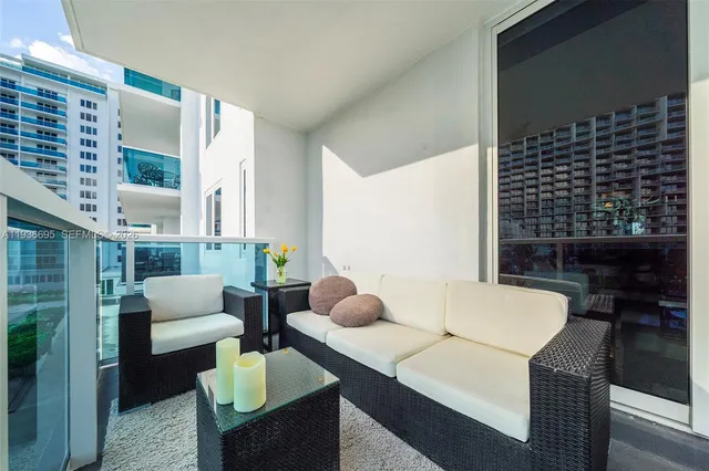 a bedroom with furniture and a large window