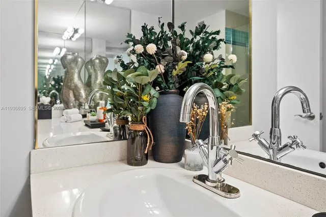 a bedroom with a bed and a lamp with the dresser