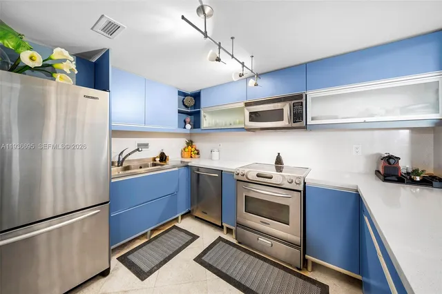 a kitchen with stainless steel appliances granite countertop a sink and cabinets